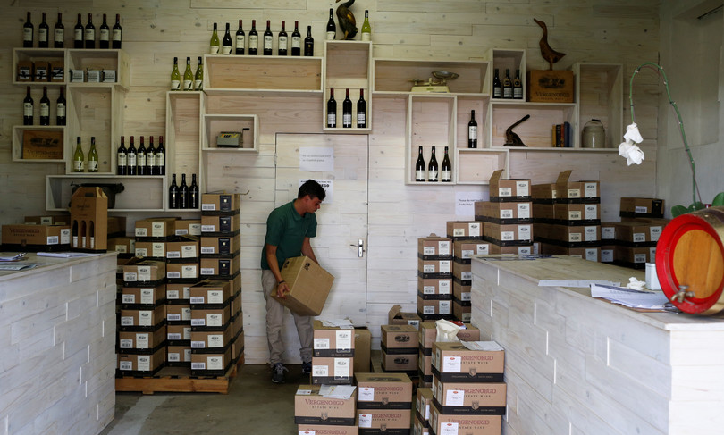 A farmworker stacks boxes of wine for sale at the Vergenoegd wine estate near Cape Town, South Africa, May 2016. In the case of State v Rodriquez, similar wine boxes arranged on pallets were used to conceal heroin.
