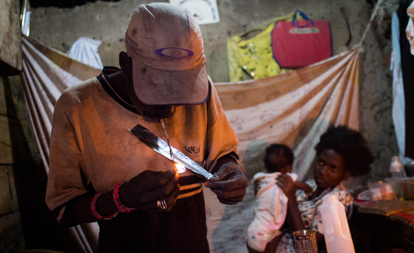 Lighting up a homemade heroin pipe in Kampala, Uganda. Under Uganda’s drugs legislation, the value of the drugs seized has an impact on the penalty given in drugs possession and trafficking cases.
