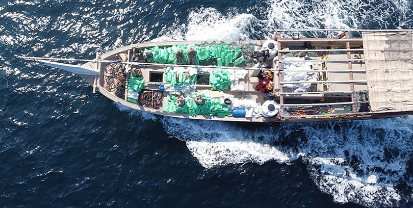A dhow found to be carrying 1 400 assault rifles, believed to be travelling from Iran to supply Houthi rebels in Yemen in December 2021. The green packaging seen on the deck of the ship is consistent with previous seizures of this kind.
