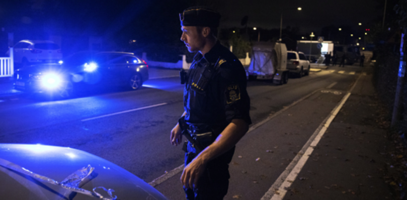 A Swedish policeman investigates a crime scene.
