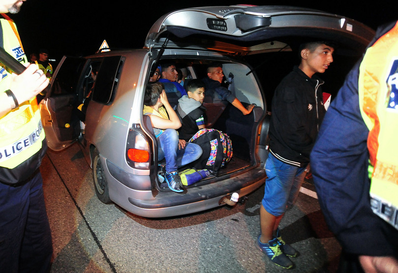 Migrant smuggling is a profitable business in the Western Balkans. Here, a migrant family is stopped by police after a smuggler’s arrest near the Serbia–Hungary border.
