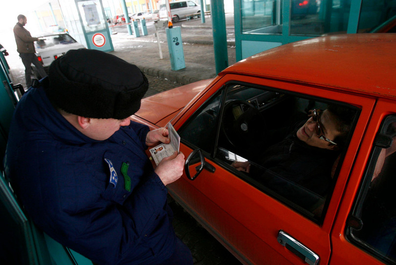 A customs officer checks a passport at the Horgos crossing at the Serbia–Hungary border in December 2009. The EU allowed visa-free travel inside the 27-country bloc for Serbia, Macedonia and Montenegro from 19 December.
