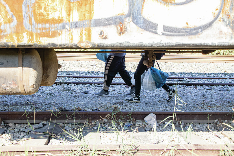 Migrants seen next to abandoned train carriages near Thessaloniki, Greece, on their way to follow the Western Balkan route towards North Macedonia, October 2022.
