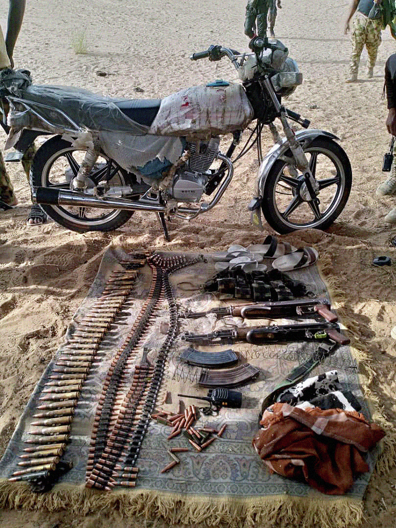Items seized from ISWAP, including a motorbike, weapons and ammunition, by military officials from Operation Lake Sanity.
